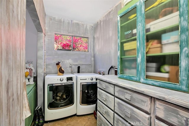 washroom with independent washer and dryer and light tile patterned floors