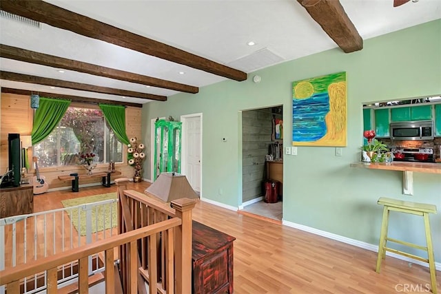 living room with beam ceiling and light hardwood / wood-style flooring