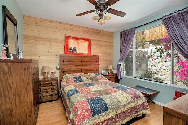 bedroom featuring multiple windows, light wood-type flooring, and ceiling fan