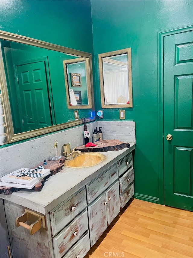 bathroom with vanity and hardwood / wood-style flooring