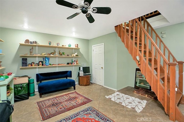 sitting room with ceiling fan and light tile patterned flooring