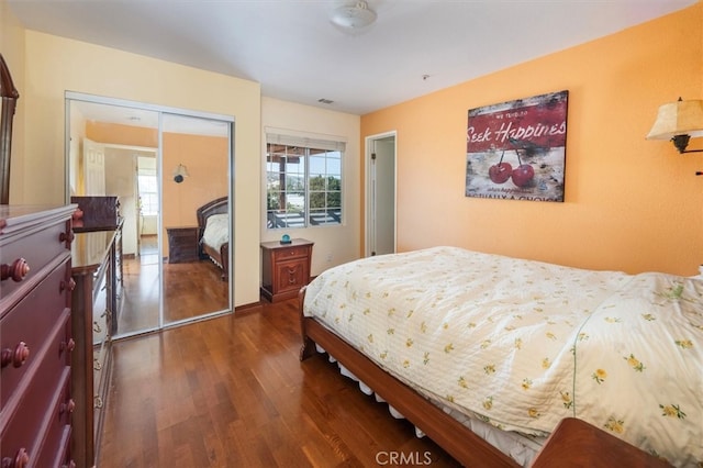 bedroom featuring a closet and dark hardwood / wood-style flooring