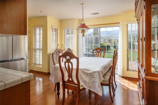 dining area featuring light wood-type flooring