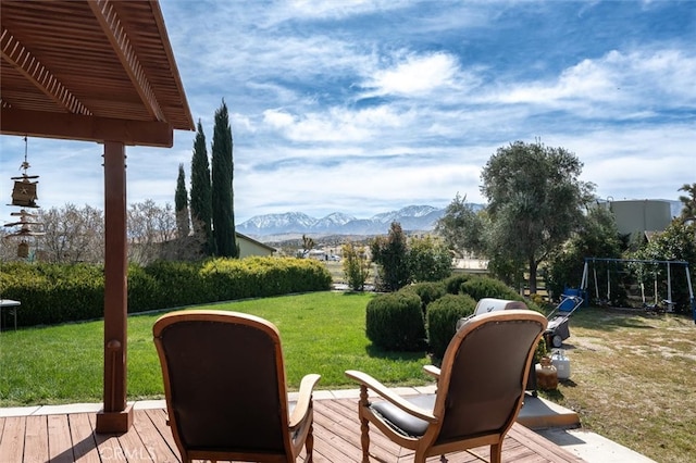 view of yard with a deck with mountain view