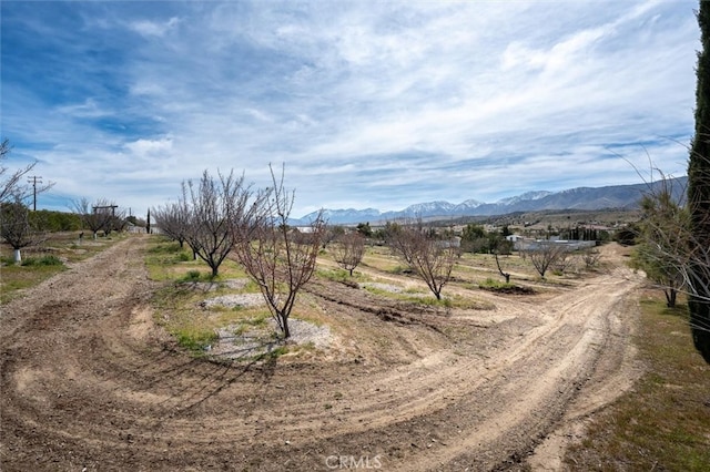 view of street with a mountain view and a rural view