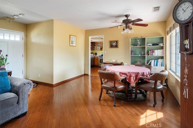 dining area with ceiling fan and hardwood / wood-style flooring