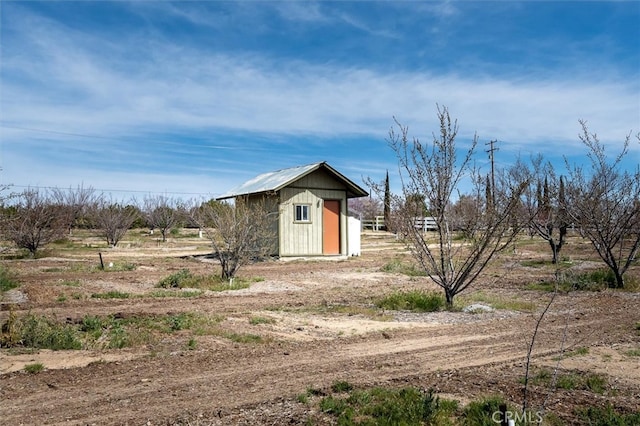 exterior space with a storage shed and a rural view