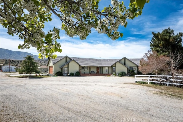 ranch-style house featuring a mountain view and covered porch