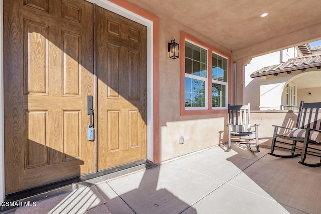 property entrance featuring covered porch