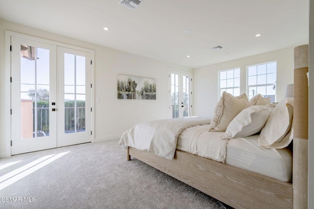 carpeted bedroom with access to exterior and french doors