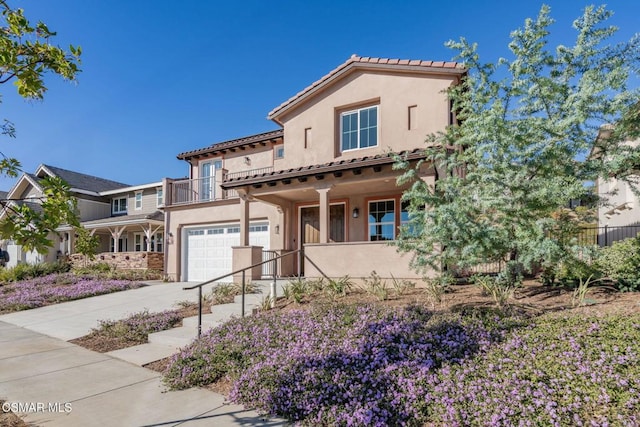 mediterranean / spanish-style home with a balcony and a garage