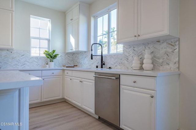 kitchen with white cabinetry, a wealth of natural light, and sink