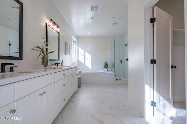 bathroom with vanity and separate shower and tub