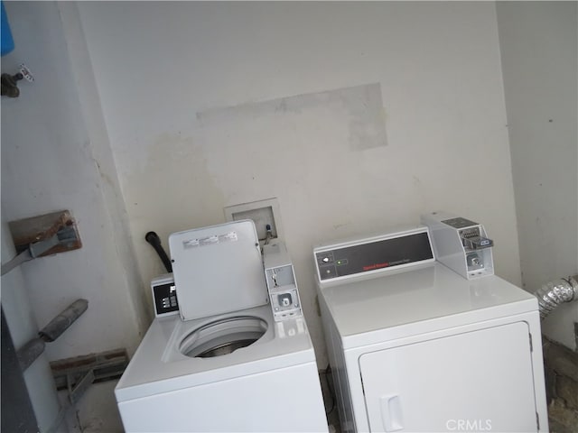 clothes washing area with washer and dryer