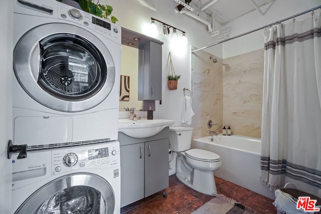 full bathroom with stacked washing maching and dryer, vanity, toilet, and shower / bath combo with shower curtain