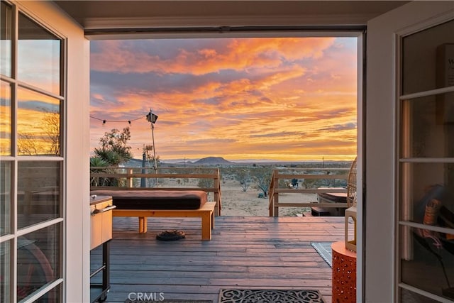 balcony at dusk featuring a mountain view