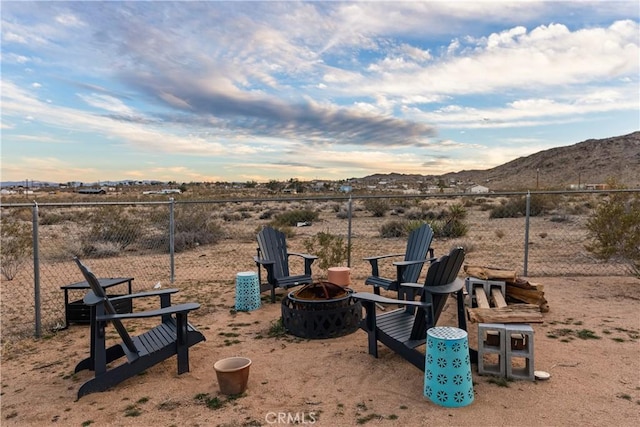 view of yard with a mountain view and an outdoor fire pit