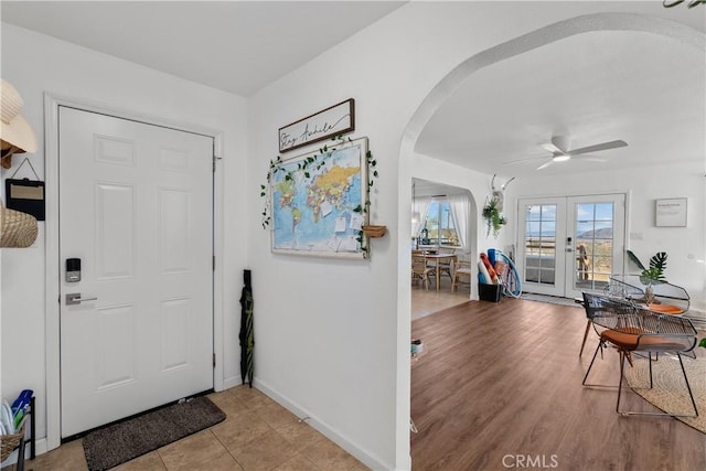 entryway with french doors, light hardwood / wood-style flooring, and ceiling fan