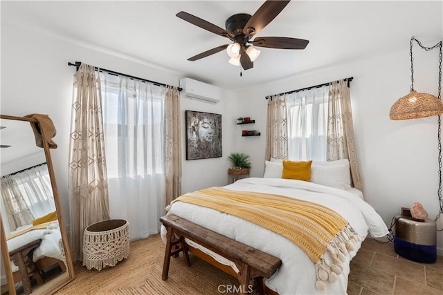 bedroom with ceiling fan and an AC wall unit