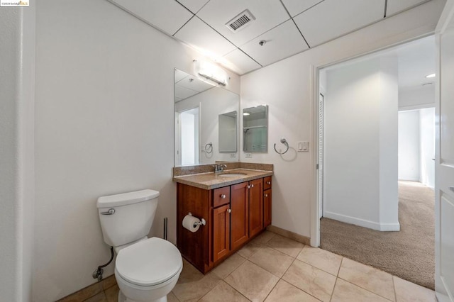 bathroom featuring tile patterned flooring, vanity, and toilet