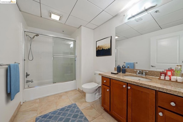 full bathroom featuring tile patterned flooring, combined bath / shower with glass door, vanity, and toilet