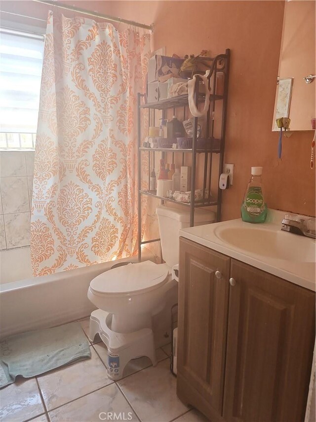 full bathroom featuring shower / bath combo with shower curtain, toilet, vanity, and tile patterned flooring