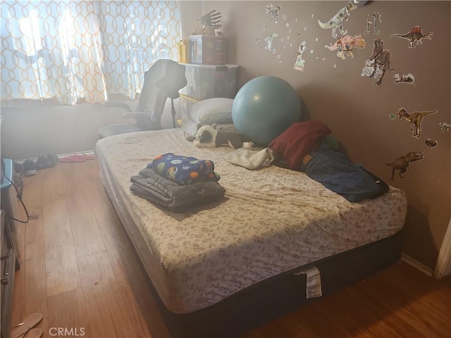 bedroom with hardwood / wood-style floors