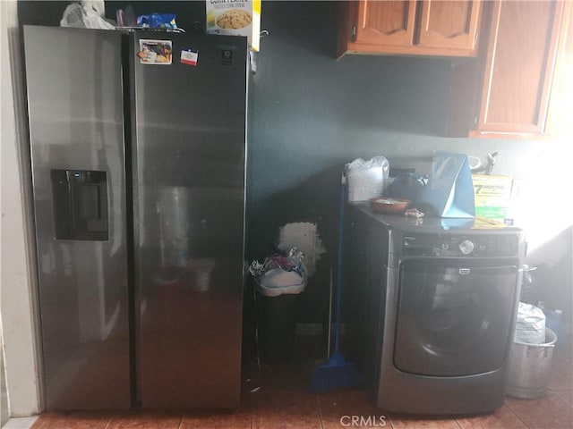 interior space featuring cabinets, washer / dryer, and tile patterned flooring