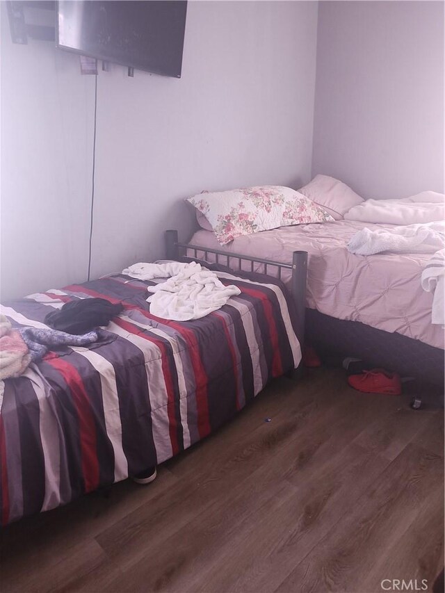 bedroom featuring dark hardwood / wood-style flooring