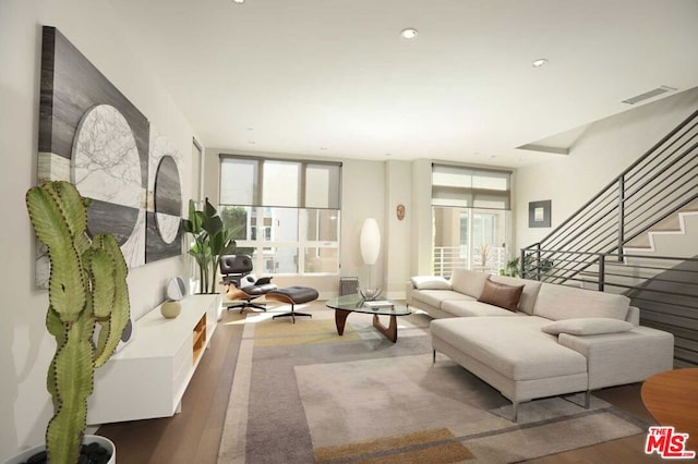 living room with a wealth of natural light and wood-type flooring