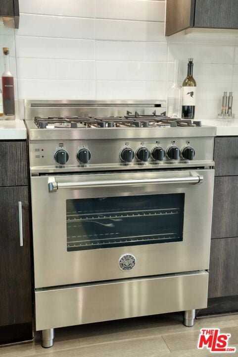 room details featuring high end range and dark brown cabinets