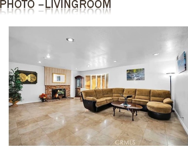 living room with a fireplace, baseboards, and recessed lighting