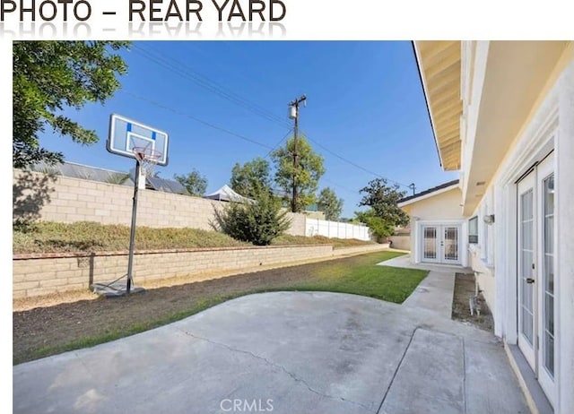 view of patio featuring a fenced backyard and french doors