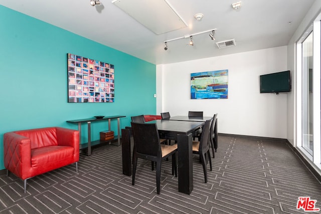 dining area featuring dark colored carpet