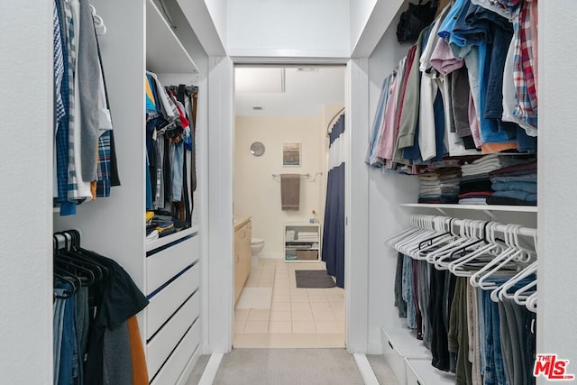 spacious closet featuring light tile patterned floors