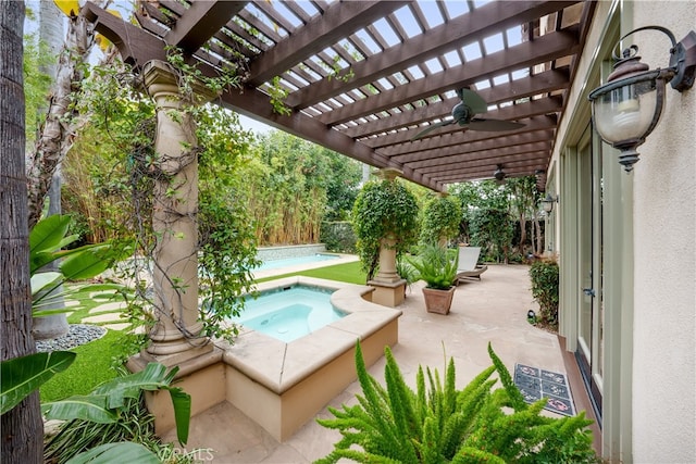 view of patio / terrace with an in ground hot tub, a pergola, and ceiling fan