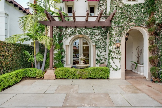 view of exterior entry featuring french doors