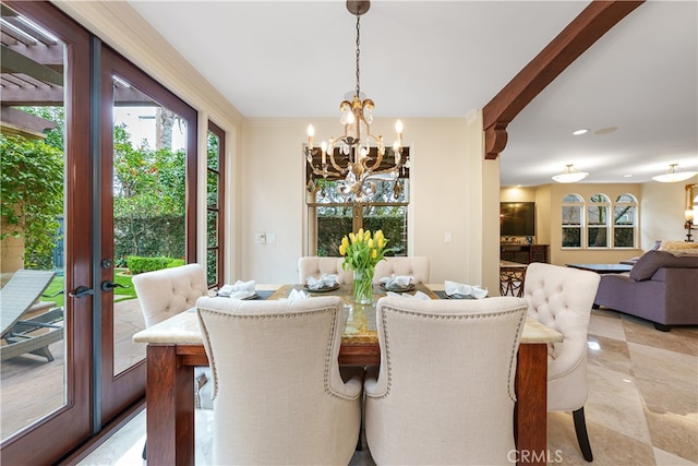 dining room featuring french doors and a chandelier