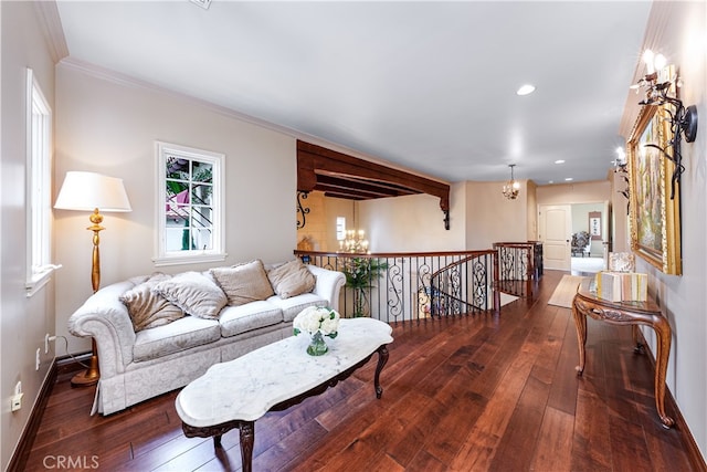 living room featuring ornamental molding, dark hardwood / wood-style flooring, and a chandelier