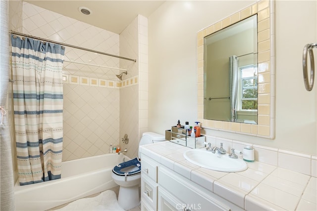 full bathroom featuring vanity, shower / bath combo with shower curtain, and toilet