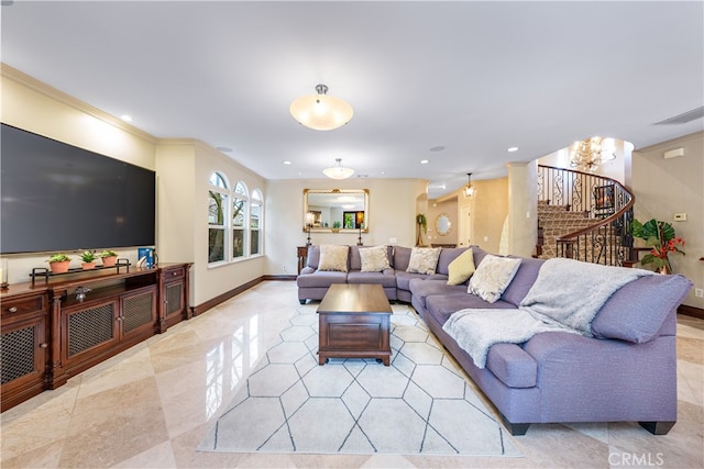 living room with crown molding and an inviting chandelier