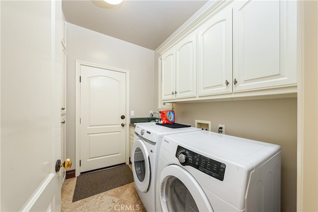 washroom featuring sink, independent washer and dryer, and cabinets