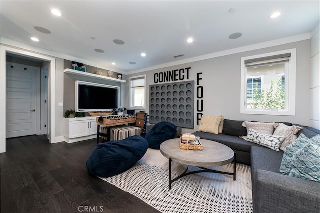 living room with ornamental molding, dark hardwood / wood-style floors, and a healthy amount of sunlight