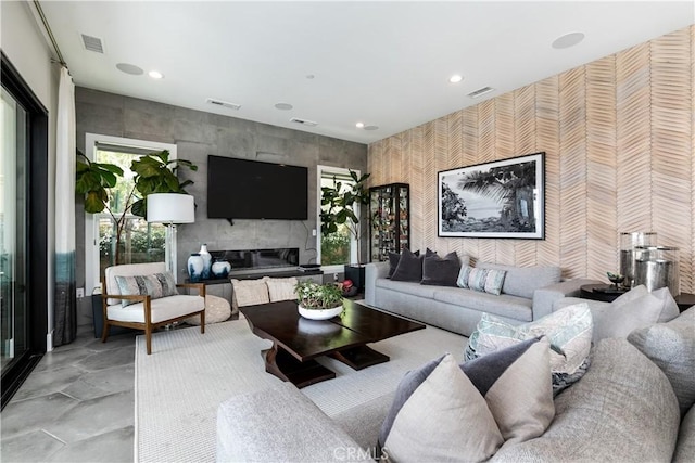 living room featuring a tiled fireplace