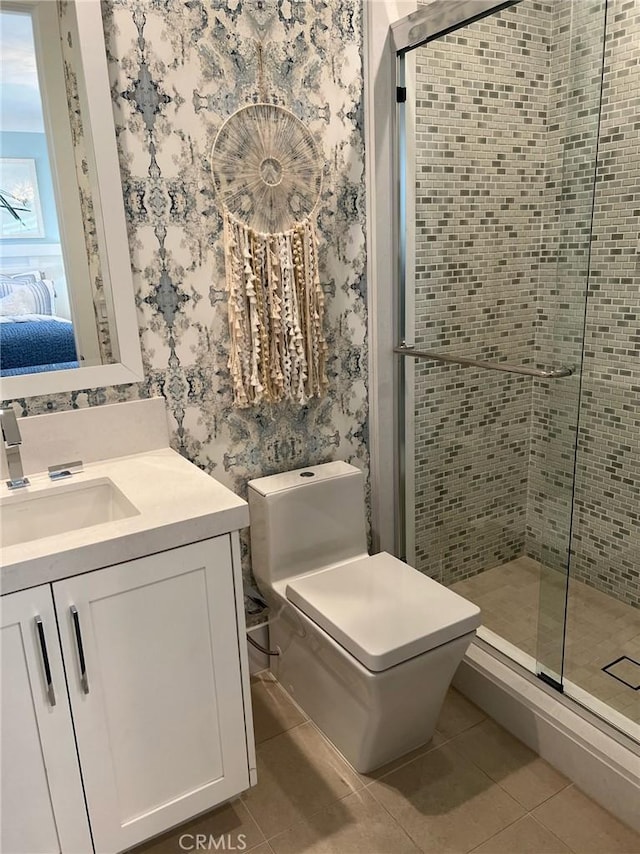 bathroom with tile patterned floors, vanity, walk in shower, and toilet