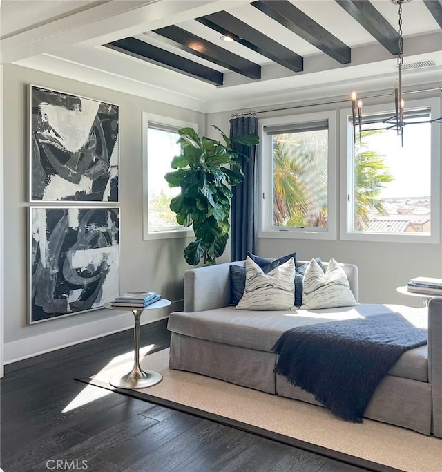 interior space featuring dark wood-type flooring, beamed ceiling, a healthy amount of sunlight, and an inviting chandelier