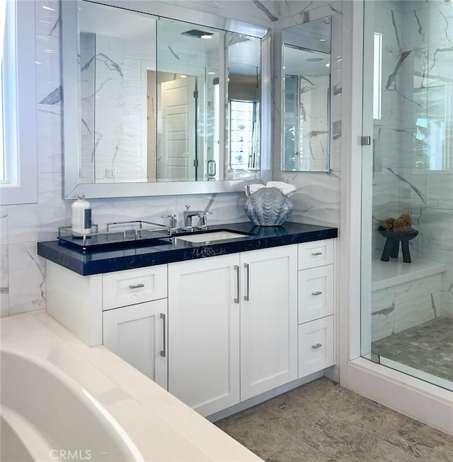 bathroom with vanity, a healthy amount of sunlight, and independent shower and bath