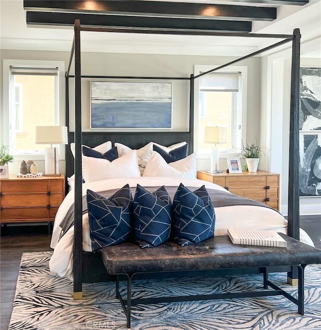 bedroom featuring beamed ceiling and dark hardwood / wood-style flooring