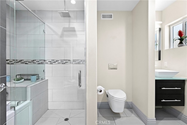 bathroom with vanity, tile patterned flooring, toilet, and an enclosed shower