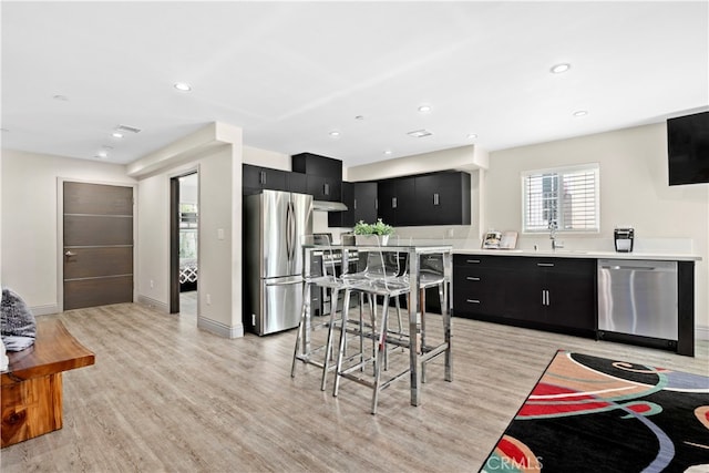 kitchen featuring light wood-type flooring, sink, and stainless steel appliances